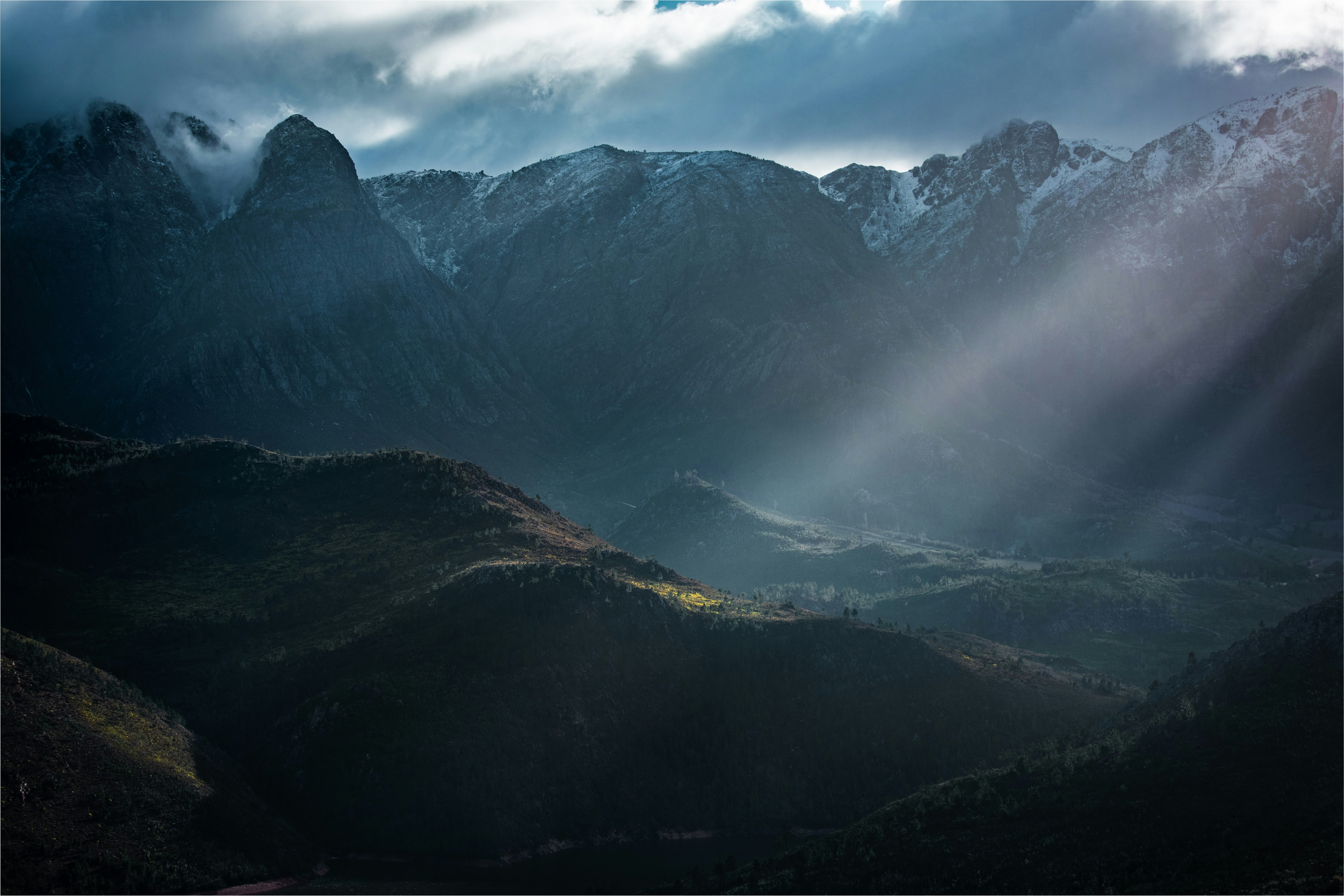 green and brown mountains under white clouds during daytime